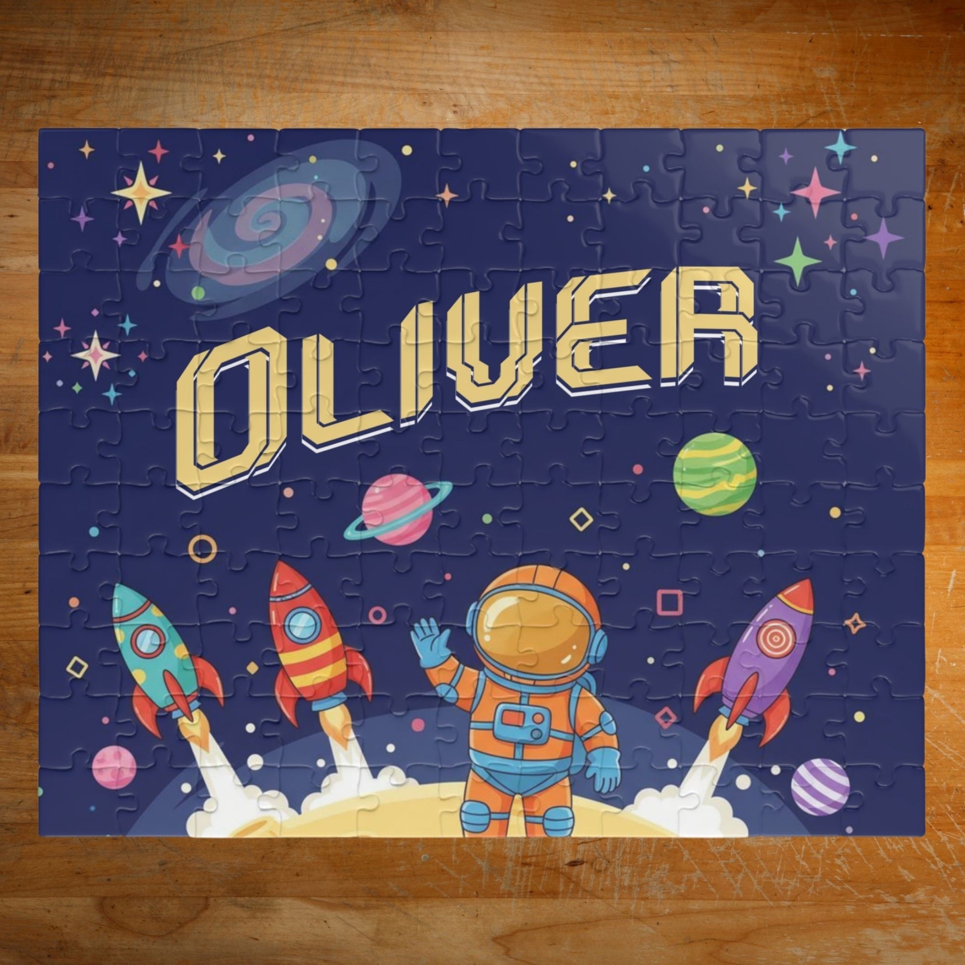 Personalized 110 piece space astronaut jigsaw puzzle featuring rockets, planets, and a cartoon astronaut, with a customizable name displayed across the center