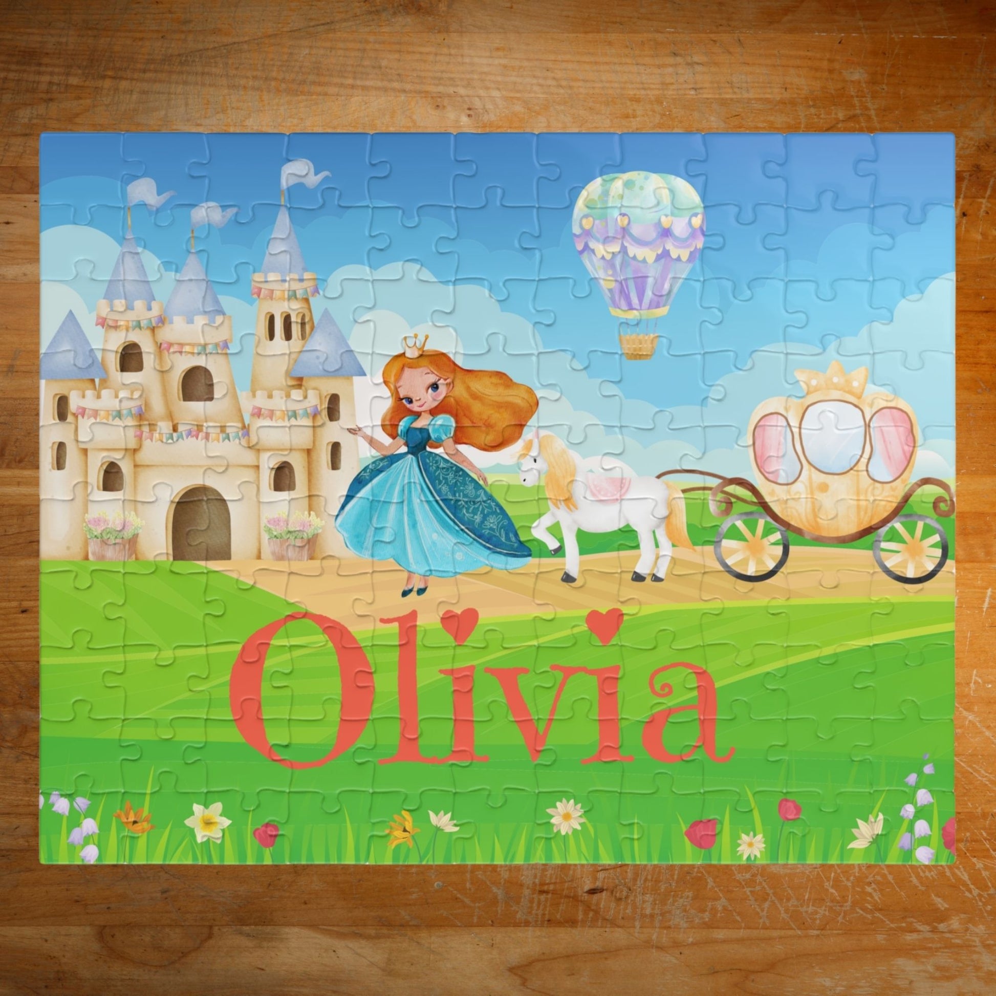 Completed personalized princess puzzle featuring a fairytale castle, princess character, horse, royal carriage, hot air balloon, bright sky, and a customizable child’s name across the grass.