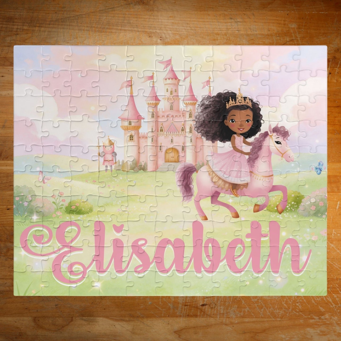 Completed personalized princess puzzle featuring a soft pastel fairytale scene with a princess on horseback, pink castle, flowers, sky, and a customizable child’s name displayed across the bottom.