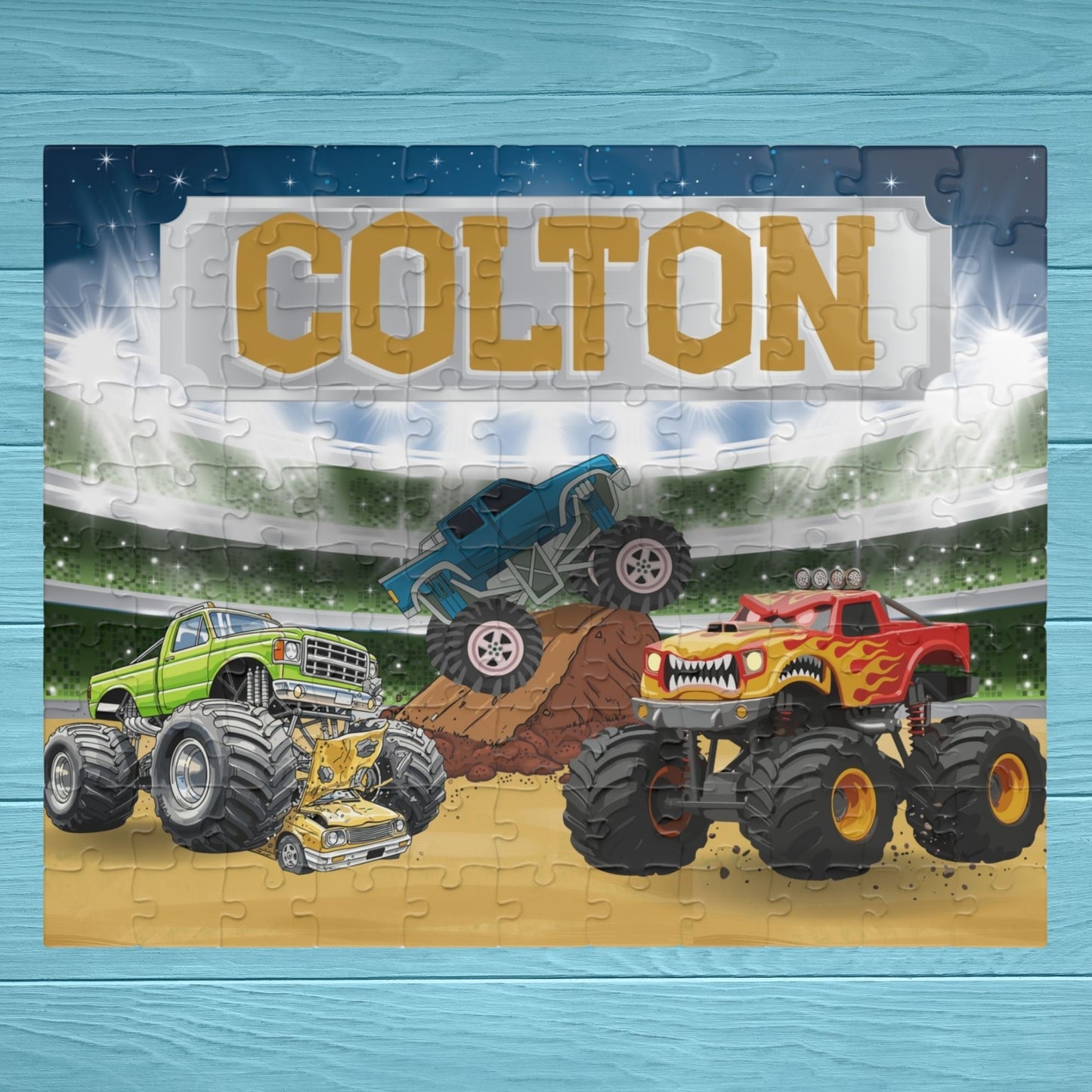 Personalized monster truck puzzle with customizable name displayed across the top, featuring a stadium scene with colorful trucks in action and bold, kid-friendly design.