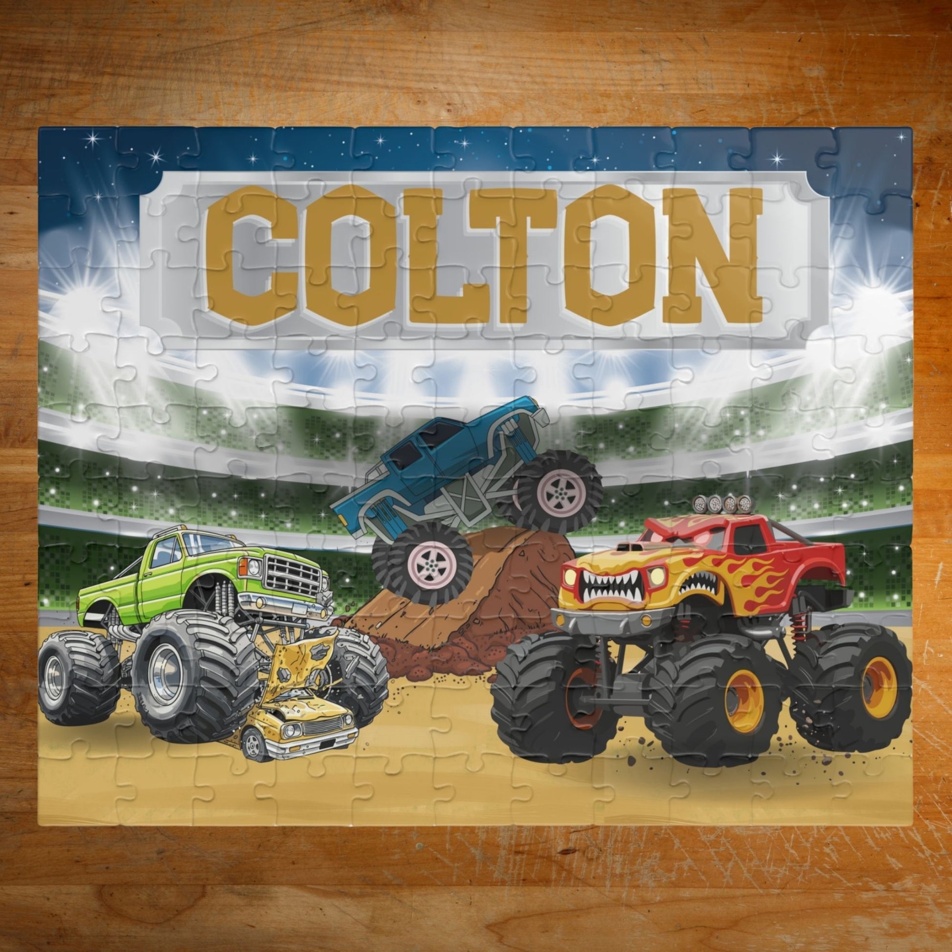 Personalized monster truck puzzle with customizable name displayed across the top, featuring a stadium scene with colorful trucks in action and bold, kid-friendly design.