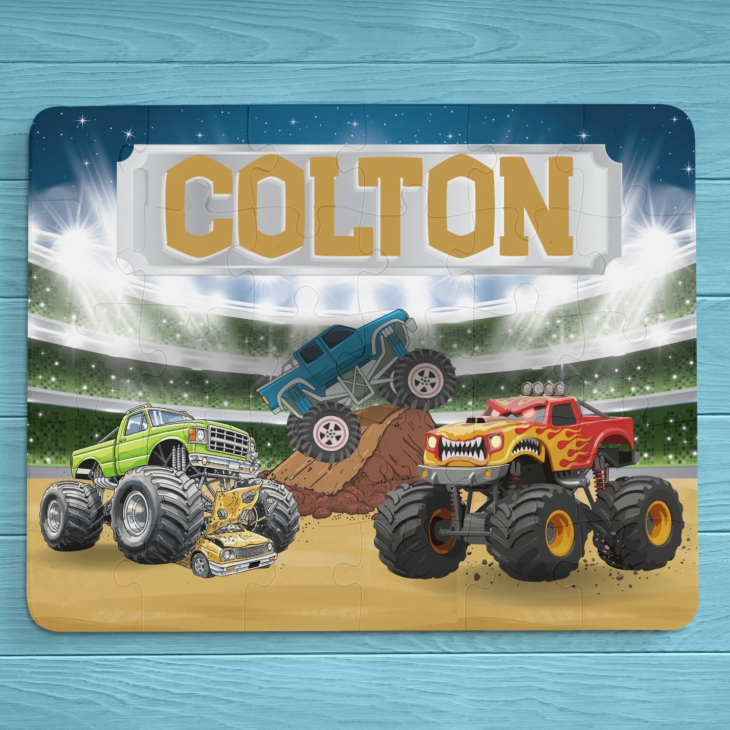Personalized monster truck puzzle with customizable name displayed across the top, featuring a colorful stadium scene and larger pieces designed for small hands.