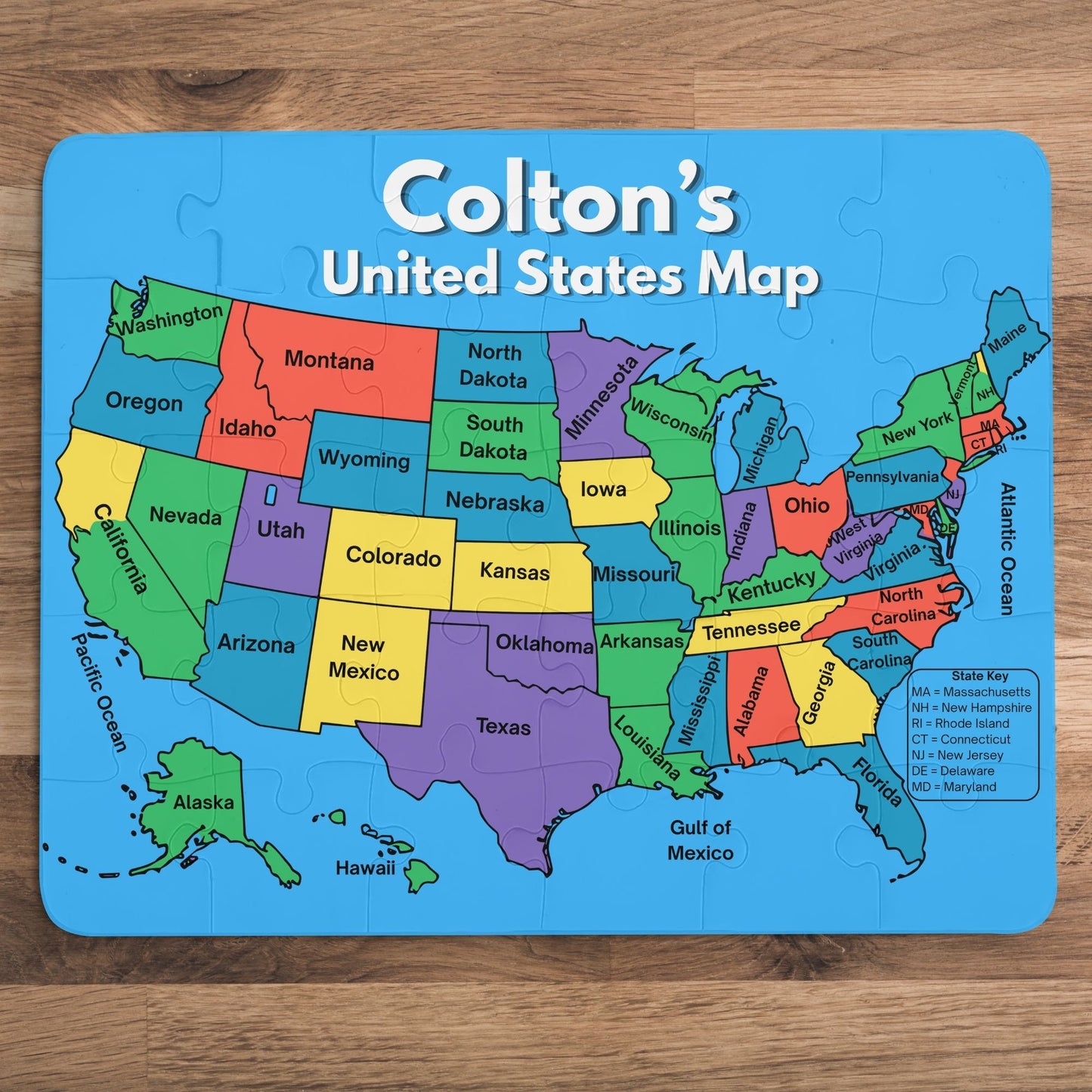Personalized 30-piece United States map puzzle featuring a child's custom name above a colorful labeled map of all 50 states with large easy-to-hold pieces.