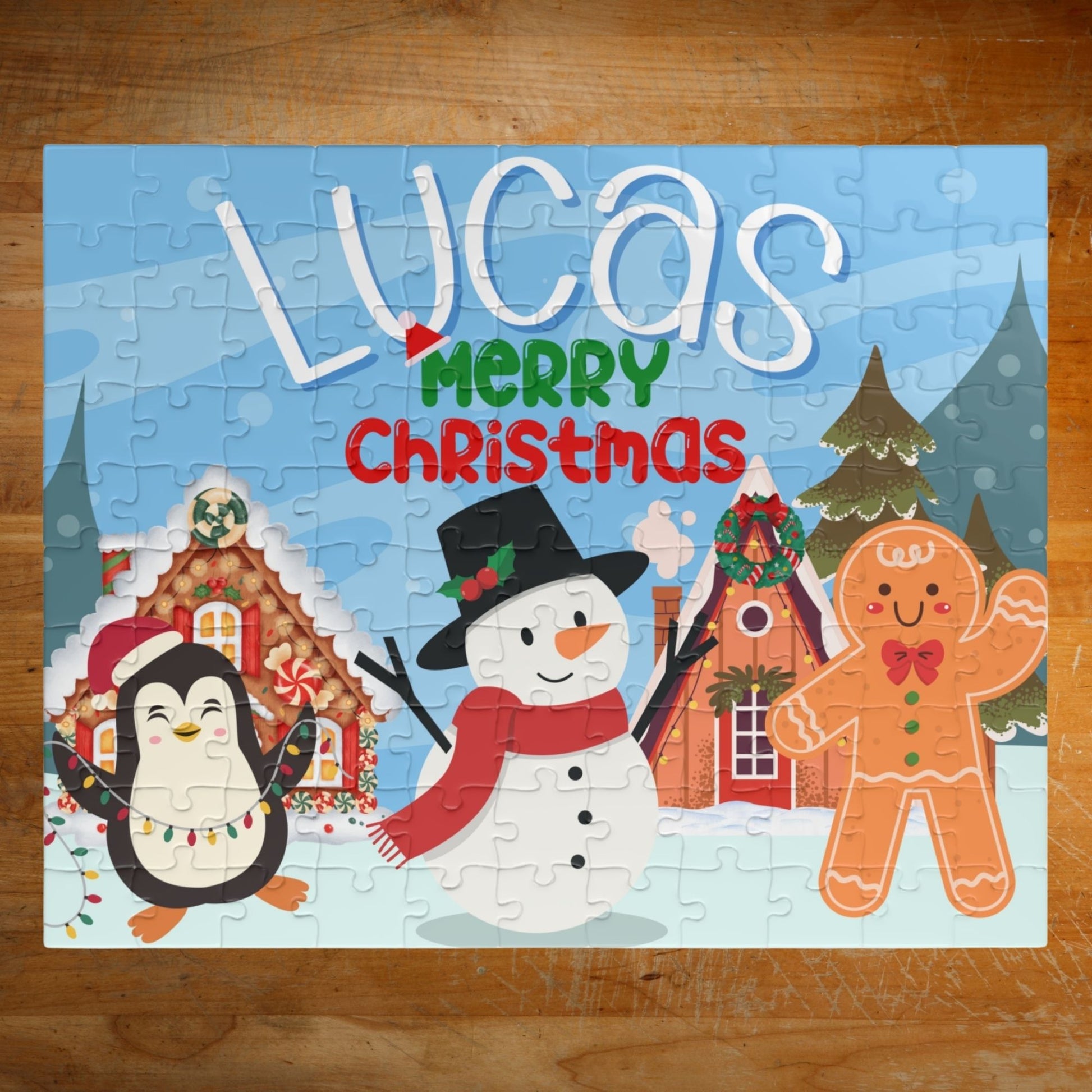 Personalized 110-piece Christmas puzzle featuring a custom name with a smiling snowman, penguin, gingerbread cookie, and festive holiday village.