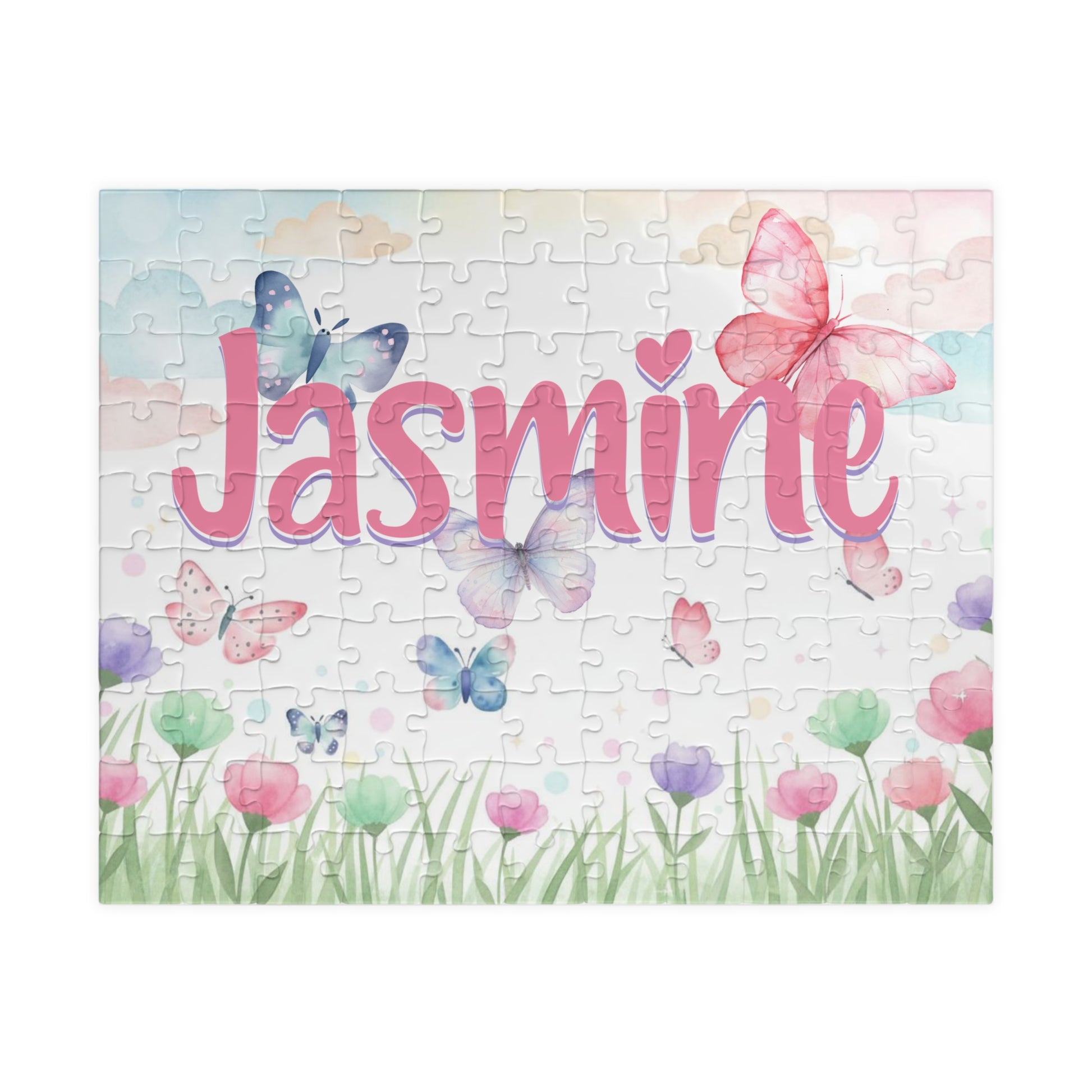 Personalized spring butterfly meadow 110-piece jigsaw puzzle featuring soft pastel flowers, grass, and fluttering butterflies. A customizable name appears prominently across the center of the puzzle design.