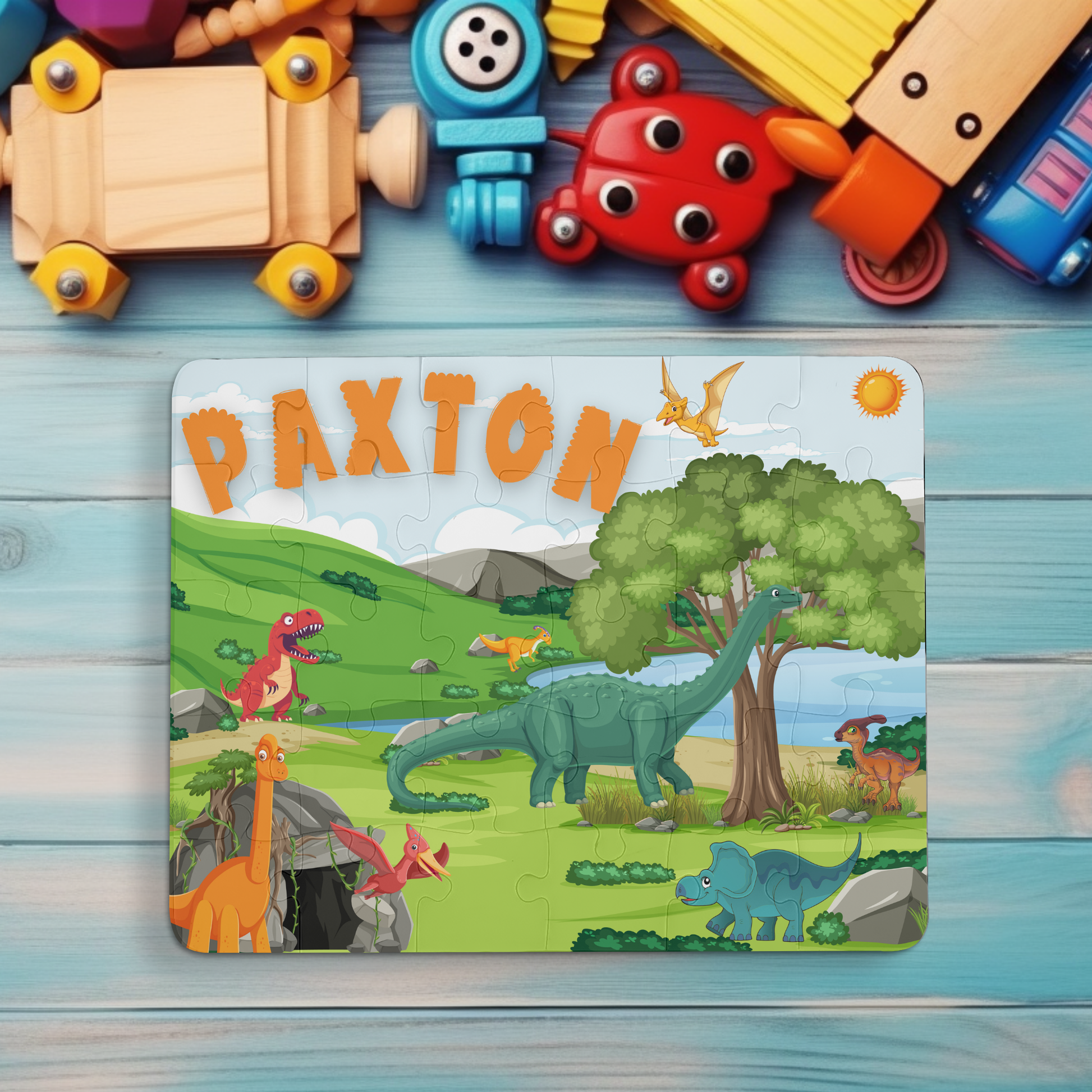 Personalized 30-piece Children&#39;s Dinosaur Puzzle. Features prehistoric background with a variety of Dinosaurs including Child&#39;s Name in Dinosaur Letters