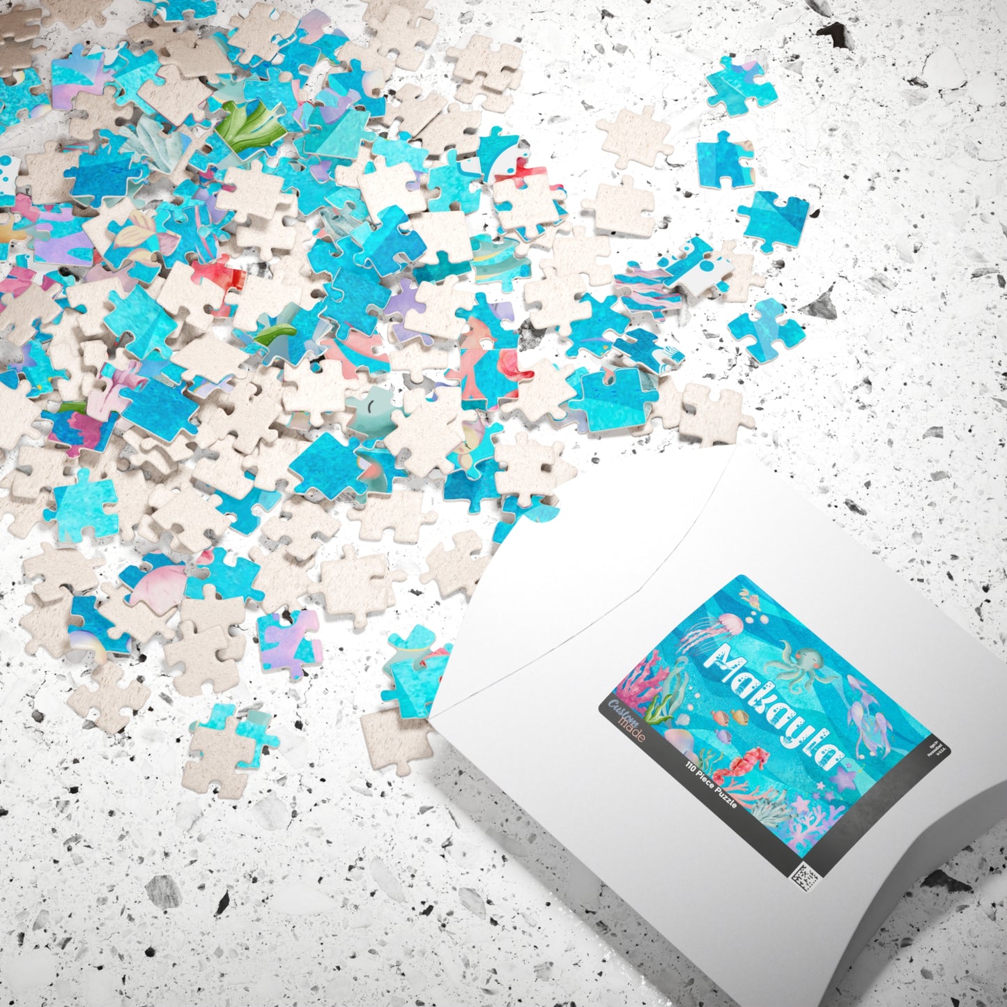 Personalized 110 piece ocean name jigsaw puzzle shown with matching puzzle box, featuring a customizable name and soft watercolor underwater design