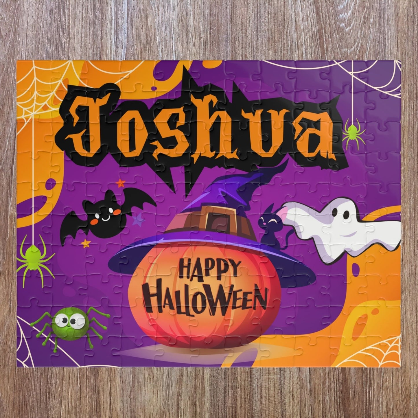 Personalized Halloween kids jigsaw puzzle with a customizable name displayed across the top, featuring a pumpkin wearing a witch hat, ghosts, bats, spiders, and purple spooky background in a 110-piece layout.