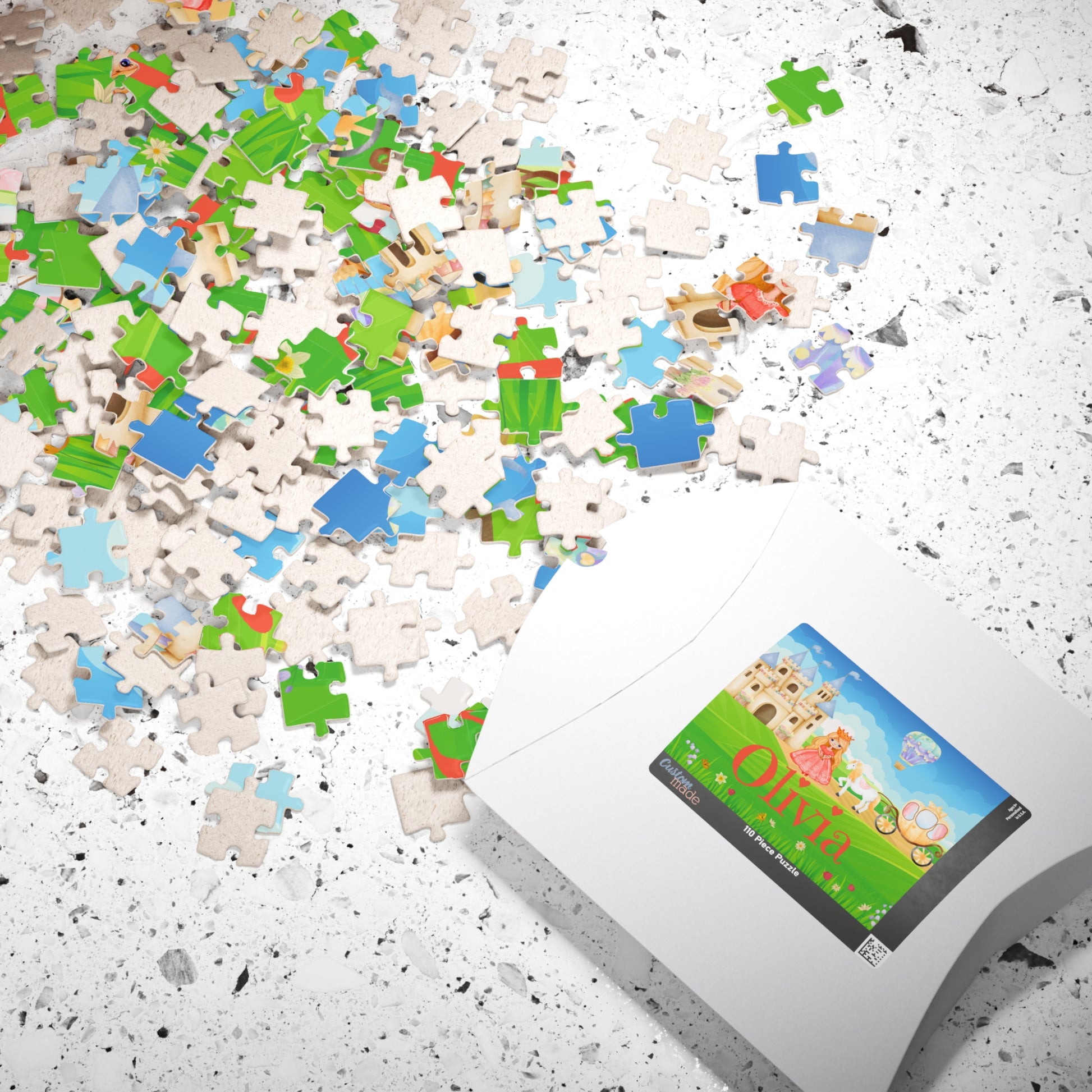 Loose jigsaw pieces scattered on a surface beside puzzle packaging displaying a personalized princess castle scene with horse, carriage, and customizable child’s name printed on the box label.
