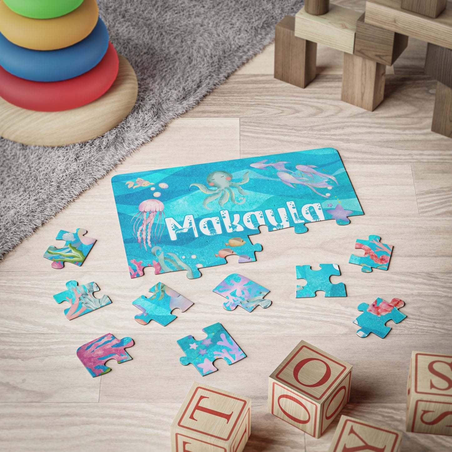 Child-sized personalized ocean jigsaw puzzle with sea animals, shown partially assembled on a playroom floor with scattered pieces for hands-on learning.