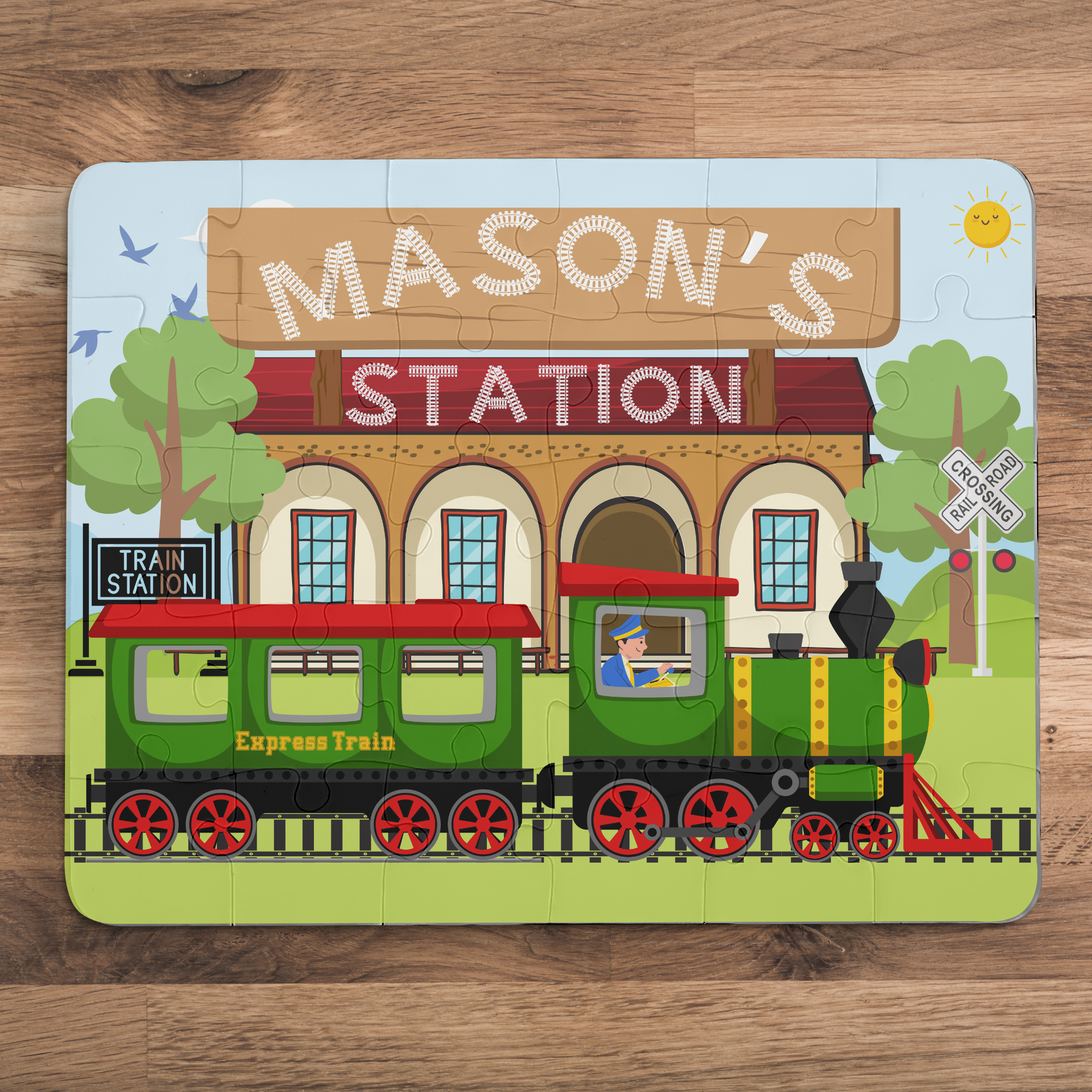 Personalized kids train station jigsaw puzzle featuring a colorful train at a station, with a customizable child’s name displayed across the top of the puzzle design.