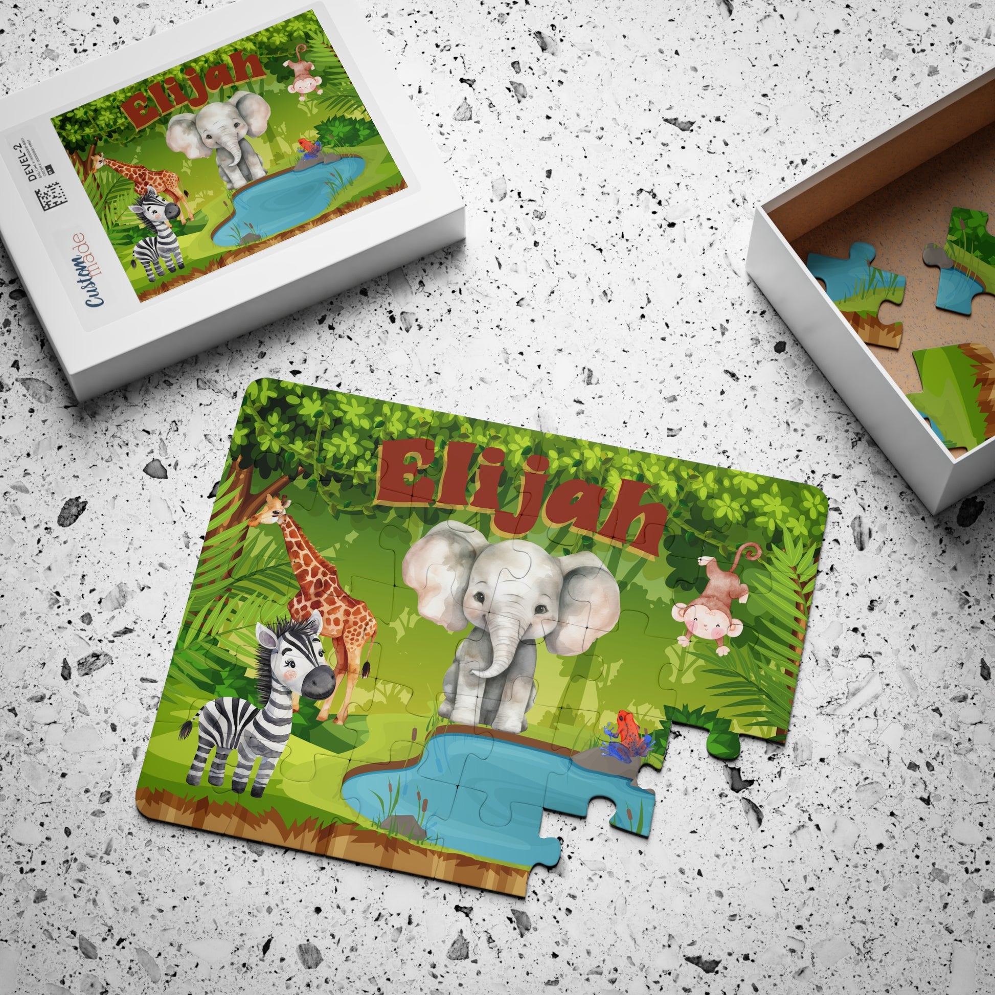 Custom jungle animal name puzzle shown with packaging, featuring a personalized child’s name printed across the top of the 30-piece jigsaw and colorful safari animal artwork.