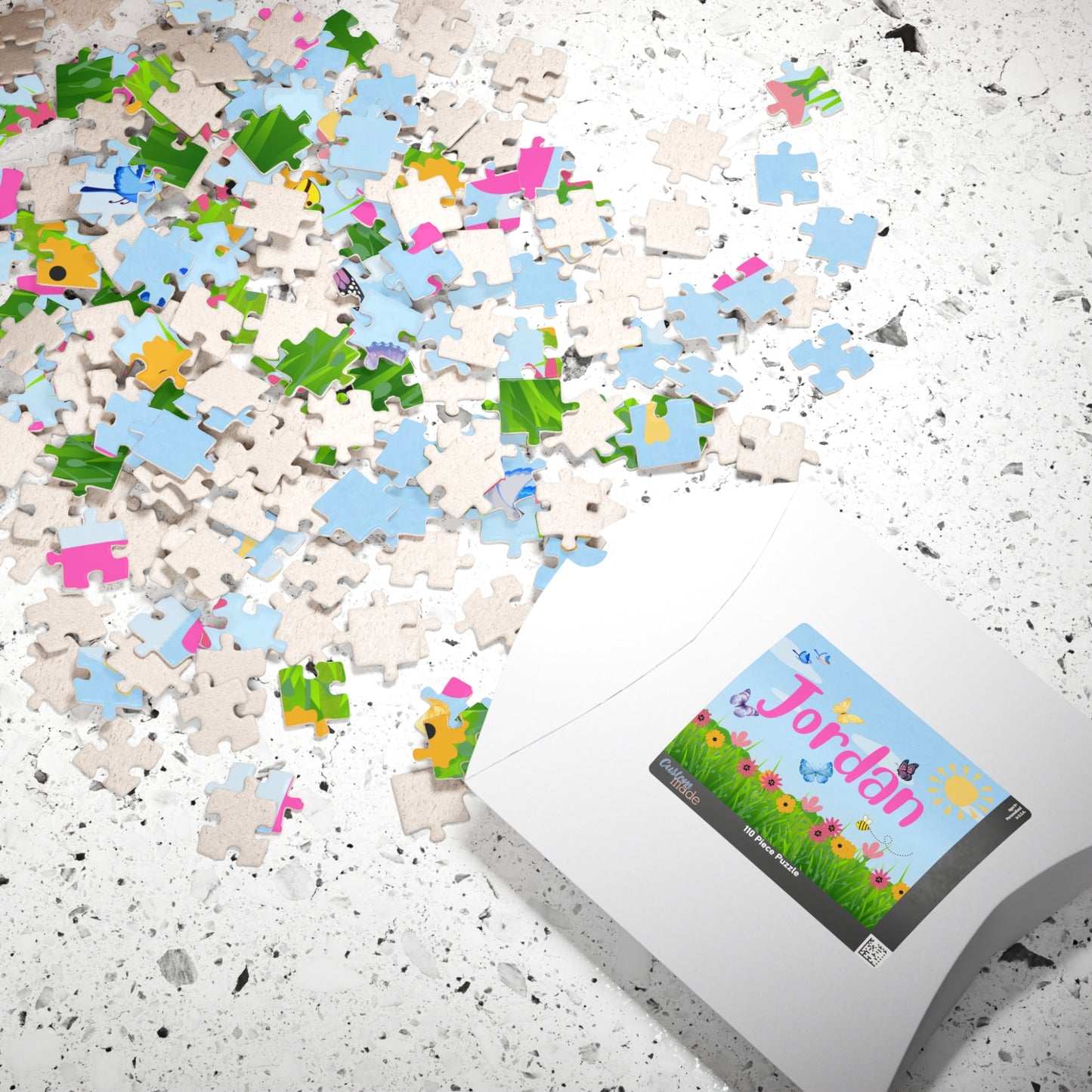 Personalized 110 piece spring name jigsaw puzzle shown with matching puzzle box, featuring a customizable name across the center and bright spring garden artwork