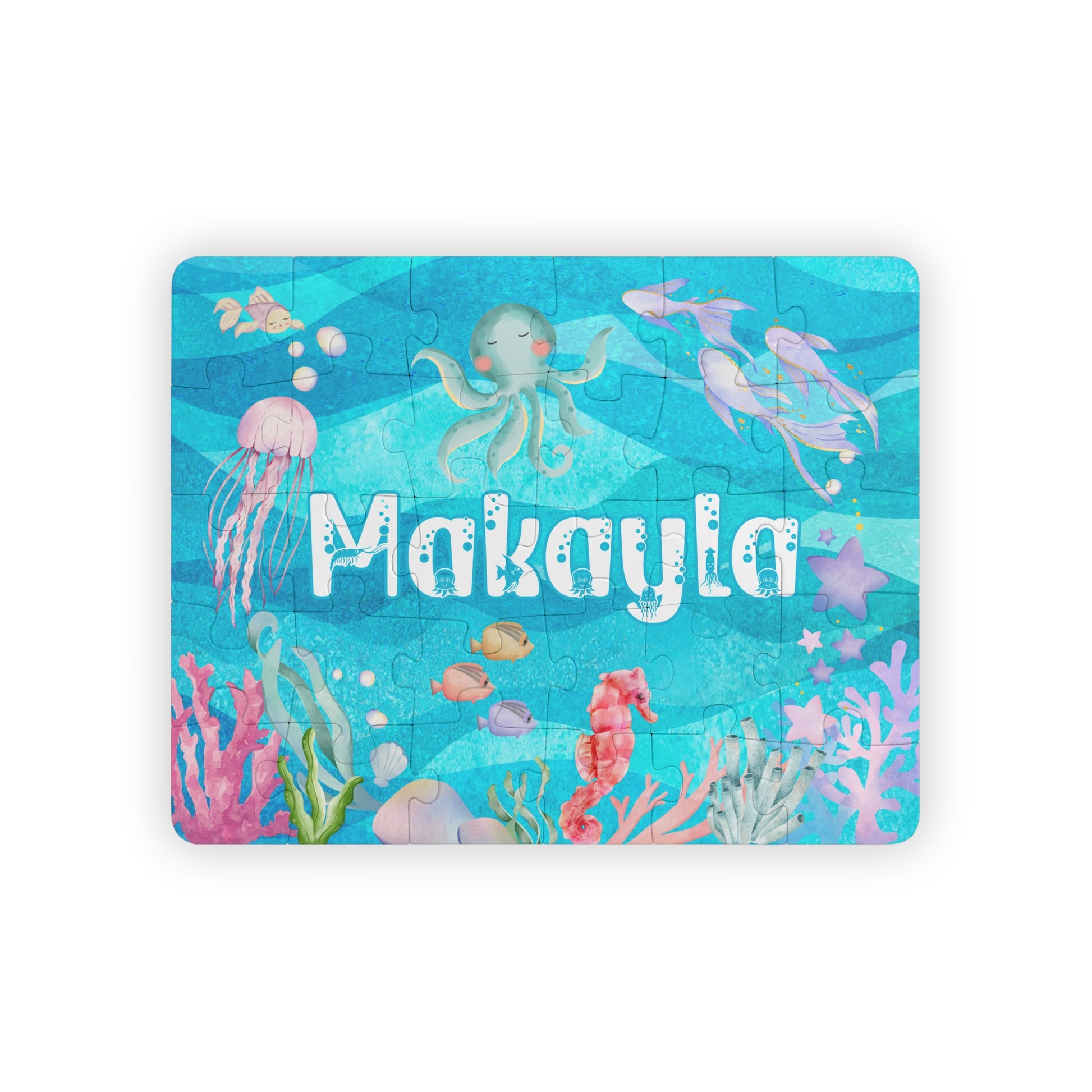 Personalized 30-piece ocean puzzle for kids featuring a colorful under-the-sea scene with an octopus, jellyfish, fish, coral, and bubbles, customized with the child’s name in large playful letters.