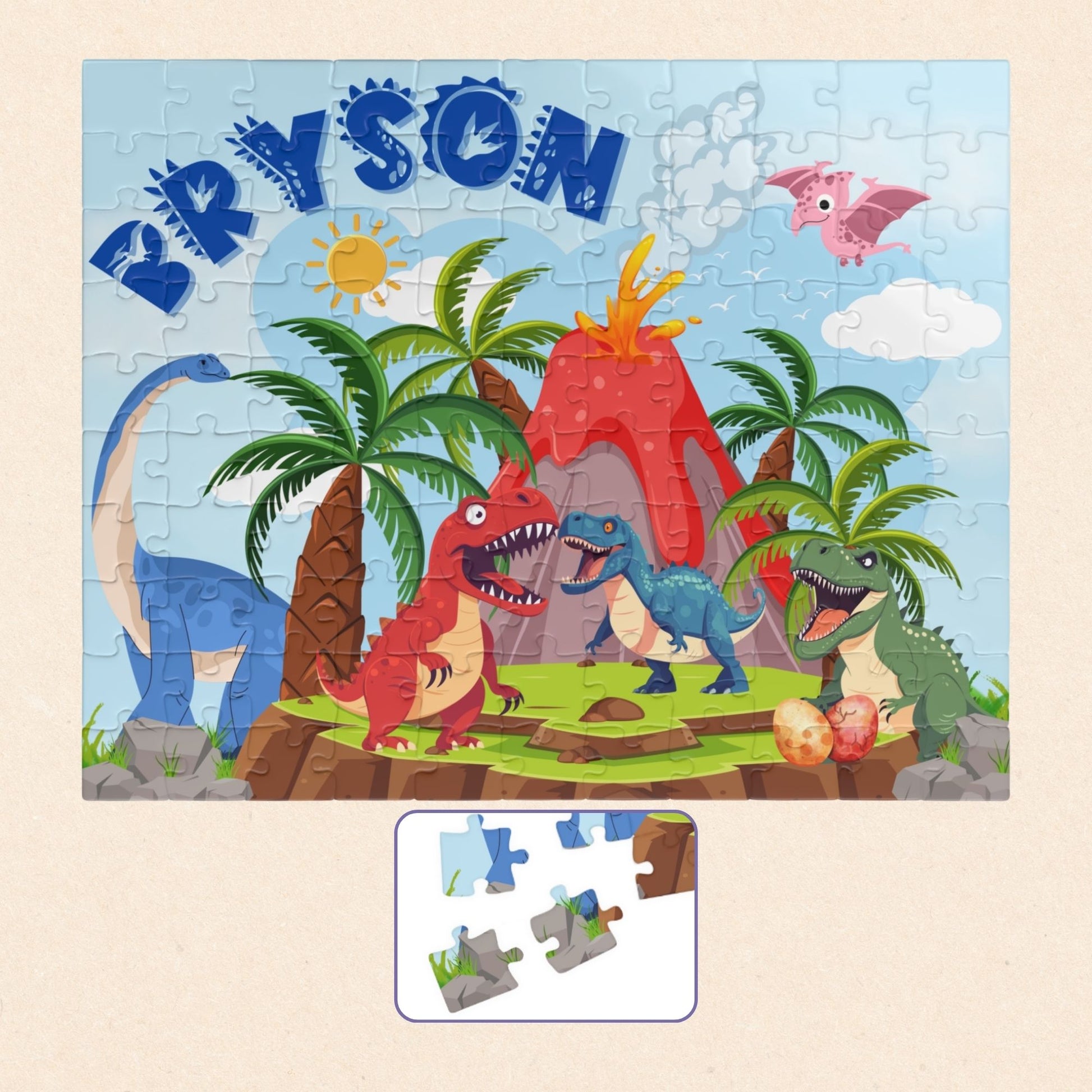 Personalized dinosaur name puzzle for kids featuring a colorful Jurassic volcano scene with multiple cartoon dinosaurs, palm trees, and a smoking volcano. The child’s name “Bryson” appears in large blue letters across the top, showing where the custom name is placed on this 110-piece jigsaw puzzle.