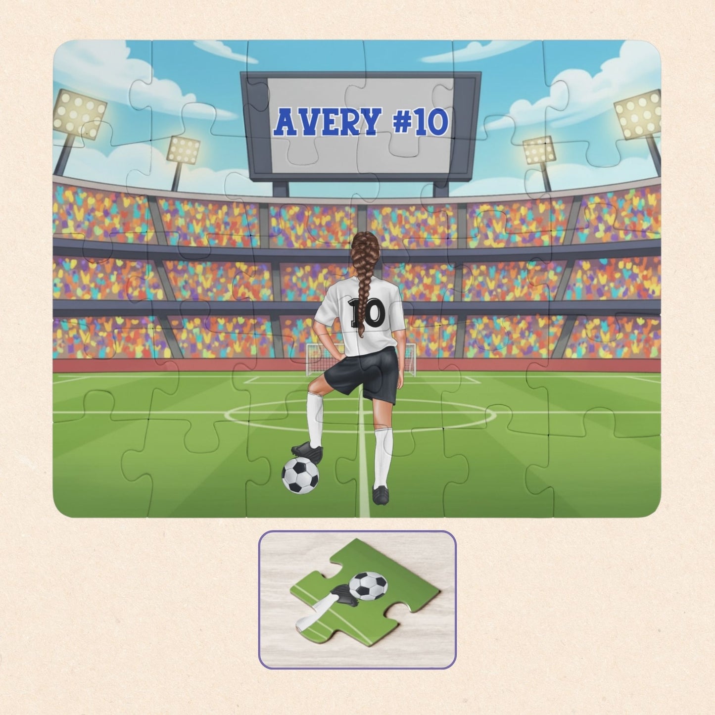 Personalized girls soccer puzzle showing a young player standing on a soccer field inside a large stadium, resting one foot on a soccer ball. The back of the jersey displays a customizable name and number, and a stadium scoreboard above also shows the personalized name and number.