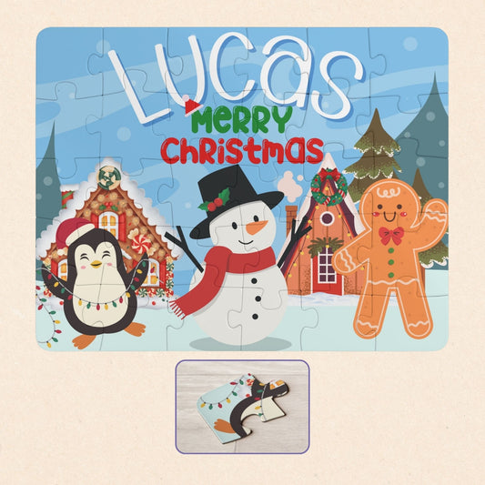 Personalized kids Christmas jigsaw puzzle featuring a winter holiday village scene with a snowman, penguin, and gingerbread character, showing a customizable name placed prominently across the top of the puzzle.