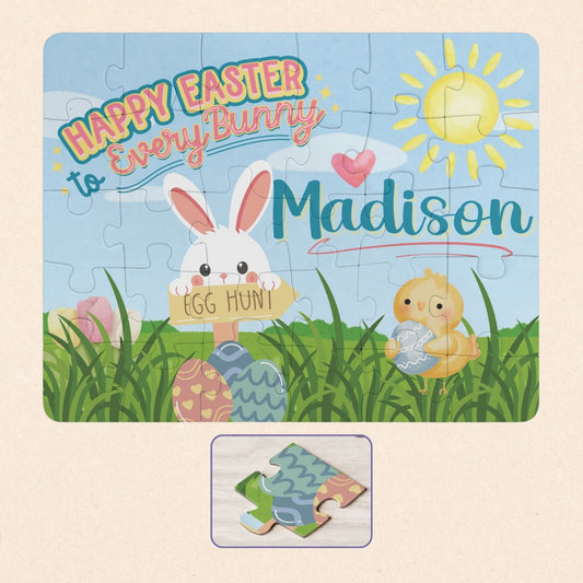 Personalized Easter bunny jigsaw puzzle for kids featuring a spring scene with a bunny holding an egg hunt sign, decorated eggs, and a chick, with a customizable child’s name displayed prominently across the top of the 30-piece puzzle.