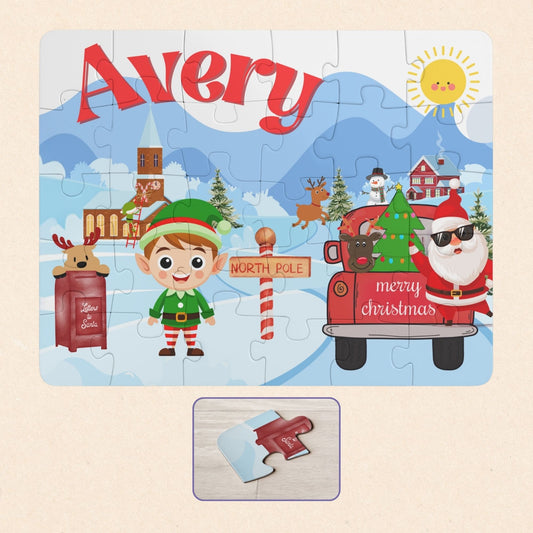 Personalized 30-piece kids Christmas jigsaw puzzle featuring a North Pole village scene with an elf, Santa, reindeer, and winter buildings, with a customizable name displayed across the top of the puzzle.