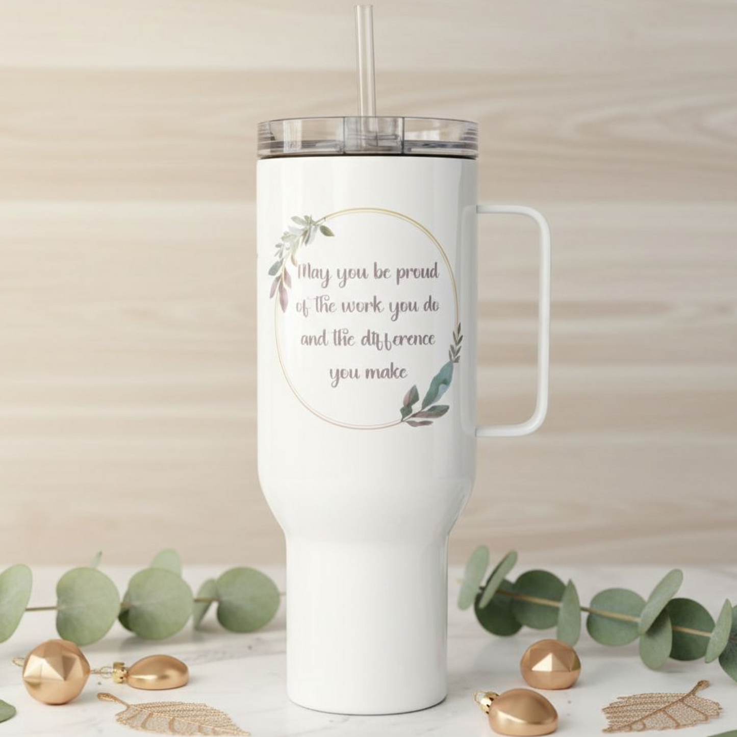 White 40 oz travel tumbler with handle and straw lid, displaying a soft floral quote design on the front with a customizable name printed on the side, photographed in a neutral home setting with woven and botanical accents.